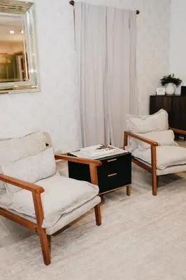 a room with two chairs and a table and a mirror at Cozy bungalow in the heart of historic Marysville in Marysville