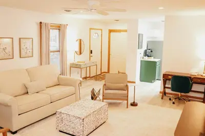 a living room with a couch and a table at Cozy bungalow in the heart of historic Marysville in Marysville