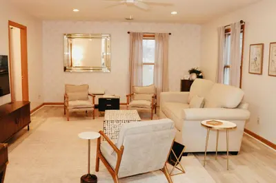 a living room with a couch and a table at Cozy bungalow in the heart of historic Marysville in Marysville