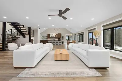 a living room with white couches and a table at Luxury Modern Lodge Near Fort Wayne with River Views