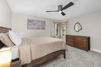a bedroom with a bed and a ceiling fan at Luxury Modern Lodge Near Fort Wayne with River Views