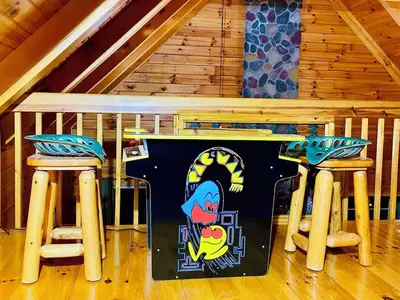 a table and two stools in a room at Breath of Heaven Cabin- Hot Tub, Deck, Pond, PETS in Logan
