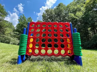 a giant board game in a grassy field at Breath of Heaven Cabin- Hot Tub, Deck, Pond, PETS in Logan
