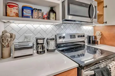 a kitchen with a stove and a microwave at Little Italy & CWRU w King BedGymParkingWD in Cleveland
