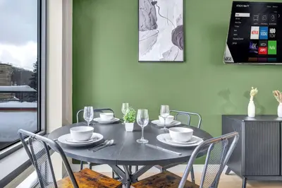 a dining room with a black table and chairs at Little Italy & CWRU w King BedGymParkingWD in Cleveland