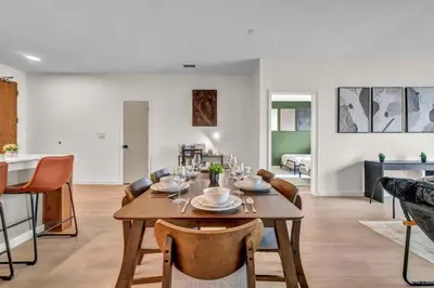 a dining room and living room with a table and chairs at Walk to CWRU w KingBed Balcony Gym Parking WD in Cleveland