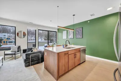 a kitchen with green walls and a sink at Cleveland Clinic w KingBed Balcony Gym Parking WD in Cleveland