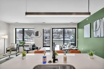 a living room with a couch and a table at Cleveland Clinic w KingBed Balcony Gym Parking WD in Cleveland
