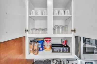 a cupboard filled with lots of food and drinks at Cleveland Clinic w KingBed Balcony Gym Parking WD in Cleveland