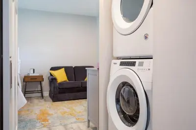 a living room with a washing machine and a couch at Perfectly Petite! in Ashland
