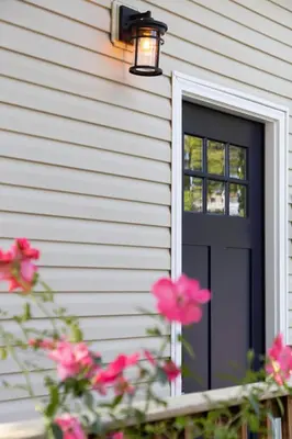 a black door on a house with pink flowers at Perfectly Petite! in Ashland