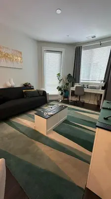 a living room with a couch and a table at Modern apt in Cincy stadiums and with river views in Cincinnati