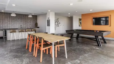 a dining room with a table and a pool table at Modern apt in Cincy stadiums and with river views in Cincinnati