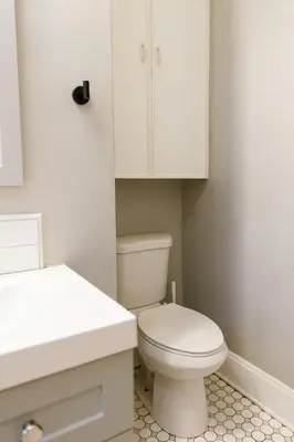 a bathroom with a white toilet and a sink at The Avon - Quaint Home in Downtown Lexington in Lexington