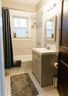 a bathroom with a sink and a tub and a window at The Avon - Quaint Home in Downtown Lexington in Lexington