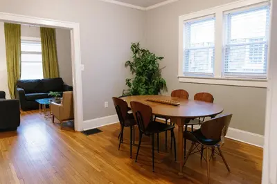 a living room with a table and chairs and a couch at The Avon - Quaint Home in Downtown Lexington in Lexington