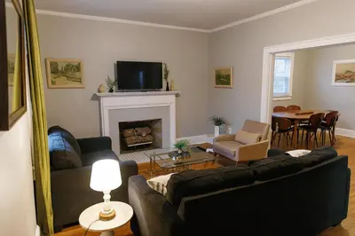 a living room with a couch and a fireplace at The Avon - Quaint Home in Downtown Lexington in Lexington