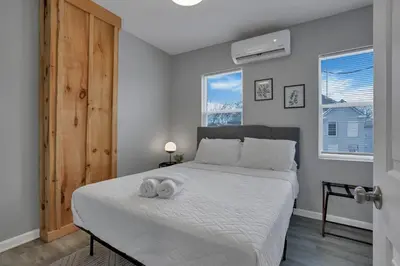 a bedroom with a bed with a towel on it at Modern 2BR Yale Townhouse Near Downtown Columbus in Columbus