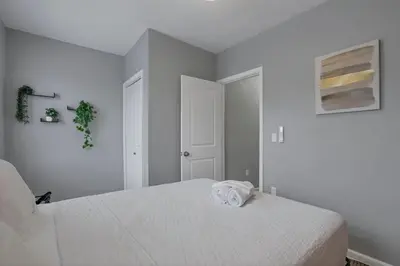 a white bedroom with a white bed in it at Modern 2BR Yale Townhouse Near Downtown Columbus in Columbus