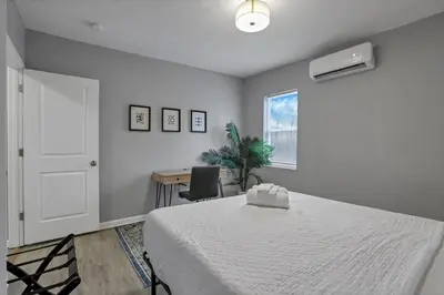 a bedroom with a bed and a desk and a window at Modern 2BR Yale Townhouse Near Downtown Columbus in Columbus