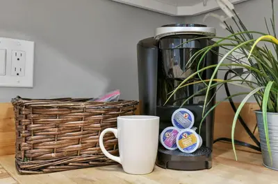 a coffee maker and a cup on a table at Modern 2BR Yale Townhouse Near Downtown Columbus in Columbus