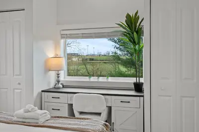 a bedroom with a window and a desk with a chair at Creekside Stay | Peaceful Cottage | Elkhorn in Georgetown