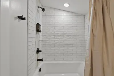 a white bathroom with a tub and a shower at Creekside Stay | Peaceful Cottage | Elkhorn in Georgetown