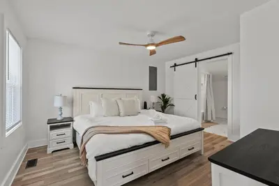 a white bedroom with a bed and a ceiling fan at Creekside Stay | Peaceful Cottage | Elkhorn in Georgetown
