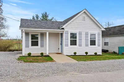 a white house with a gravel driveway at Creekside Stay | Peaceful Cottage | Elkhorn in Georgetown