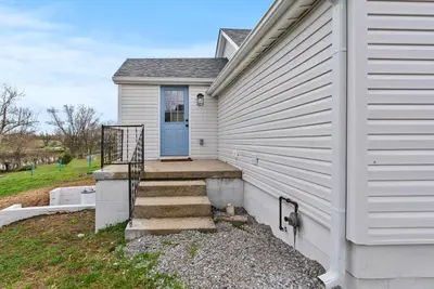 a white house with a blue door and stairs at Creekside Stay | Peaceful Cottage | Elkhorn in Georgetown