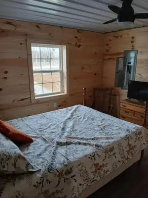 a bedroom with a bed and a window at A Million Dollar View in Owenton