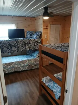 a bedroom with two bunk beds and a laptop computer at A Million Dollar View in Owenton