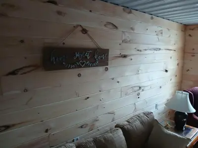 a wooden wall with a sign that reads happy first year at A Million Dollar View in Owenton