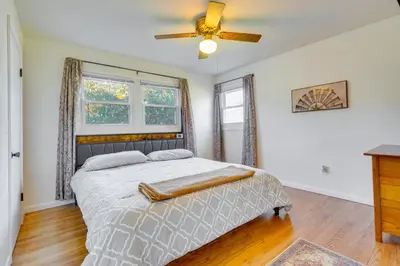 a bedroom with a bed and a ceiling fan at Hocking Hills Hideaway with Hot Tub and Games in Rockbridge