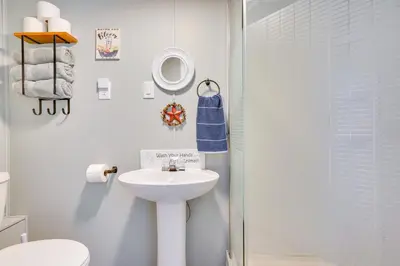 a white bathroom with a sink and a shower at Hocking Hills Hideaway with Hot Tub and Games in Rockbridge