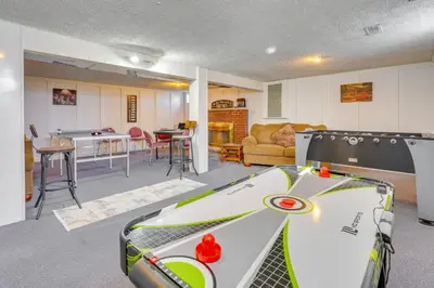 a room with a ping pong table and a living room at Hocking Hills Hideaway with Hot Tub and Games in Rockbridge