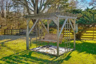 a wooden gazebo sitting in the grass at Hocking Hills Hideaway with Hot Tub and Games in Rockbridge