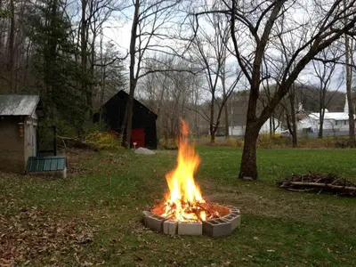 a fire pit in the grass in a yard at Alice Rocks - Pet Friendly, Firepit, WiFi in Frenchburg