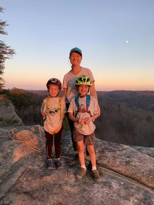 a man and two children standing on top of a rock at Alice Rocks - Pet Friendly, Firepit, WiFi in Frenchburg