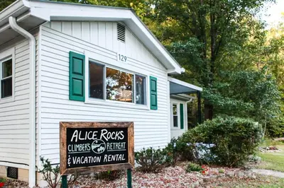 a house with a sign in front of a house at Alice Rocks - Pet Friendly, Firepit, WiFi in Frenchburg