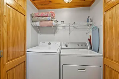a small laundry room with a washer and dryer at Birdsong- Hot Tub, Game Room, Firepit, WiFi in Stanton