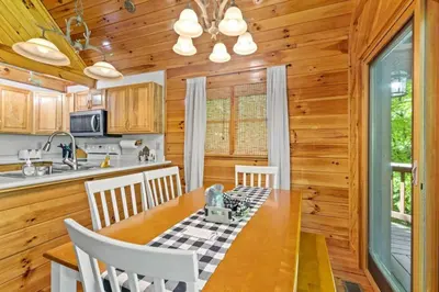 a kitchen and dining room with a table and chairs at Birdsong- Hot Tub, Game Room, Firepit, WiFi in Stanton