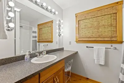 a bathroom with a sink and a mirror at Birdsong- Hot Tub, Game Room, Firepit, WiFi in Stanton