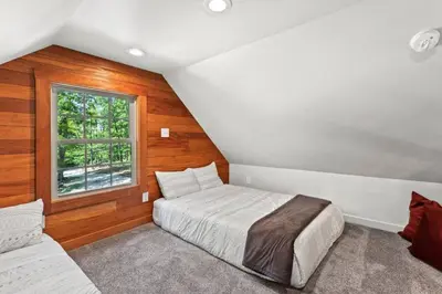 a bedroom with a bed and a window at Furnace Mountain Retreat- Hot Tub, Fireplace, WiFi in Stanton
