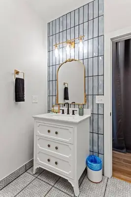 a bathroom with a white dresser and a mirror at Primrose- Hot Tub, Firepit, Wraparound Deck, WiFi in Wellington