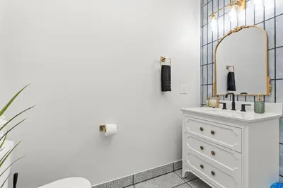 a bathroom with a white dresser and a mirror at Primrose- Hot Tub, Firepit, Wraparound Deck, WiFi in Wellington