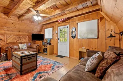 a living room with a couch and a table at Sugar Shack - Cave Run Lake OR Red River Gorge KY in Wellington