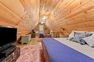 a bedroom with a large bed in a wooden ceiling at Sugar Shack - Cave Run Lake OR Red River Gorge KY in Wellington