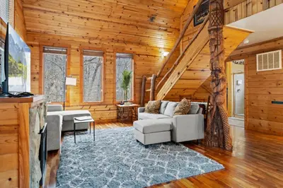 a living room with a couch and a table at Beary Cozy- No Pet Fee, Hot Tub, Fireplace, WiFi in Slade