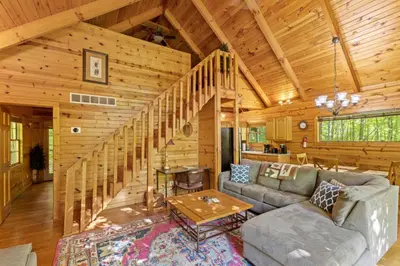 a living room with a couch and a table at Beary Secluded- No Pet Fee, Hot Tub, Firepit, WiFi in Slade